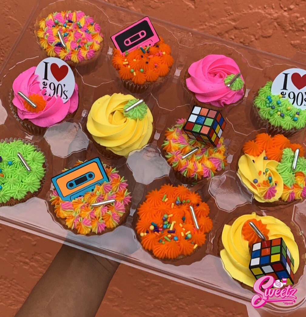 A selection of 90s cupcakes with retro toppers
