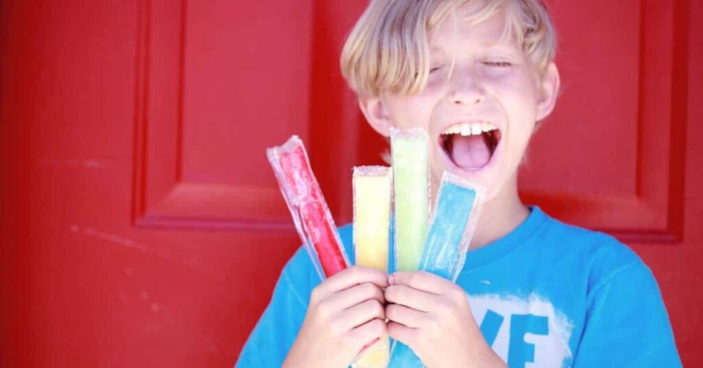 a child holding and enjoying 90s ice pops with fruity flavors