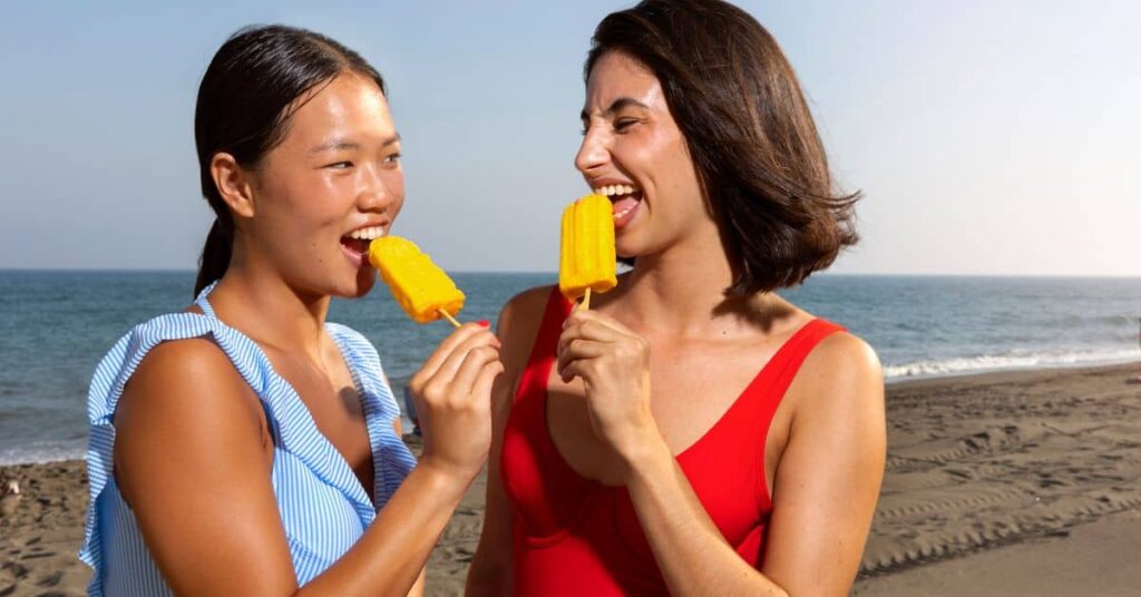 two women eating 90s ice pops on a hot summer